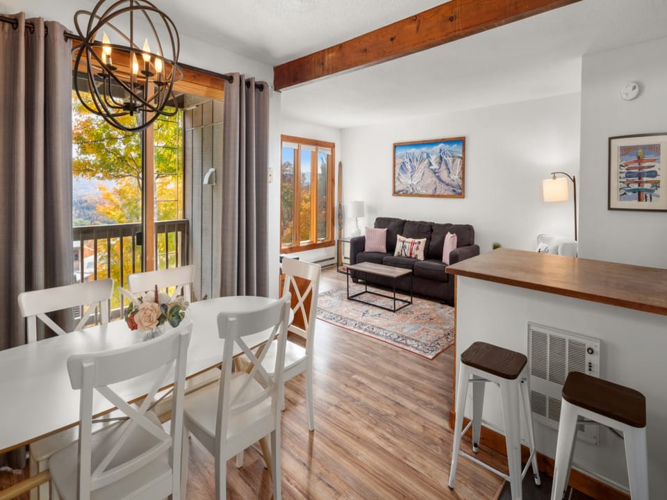 Kitchen/Dining Area with slider door to balcony and living room in background