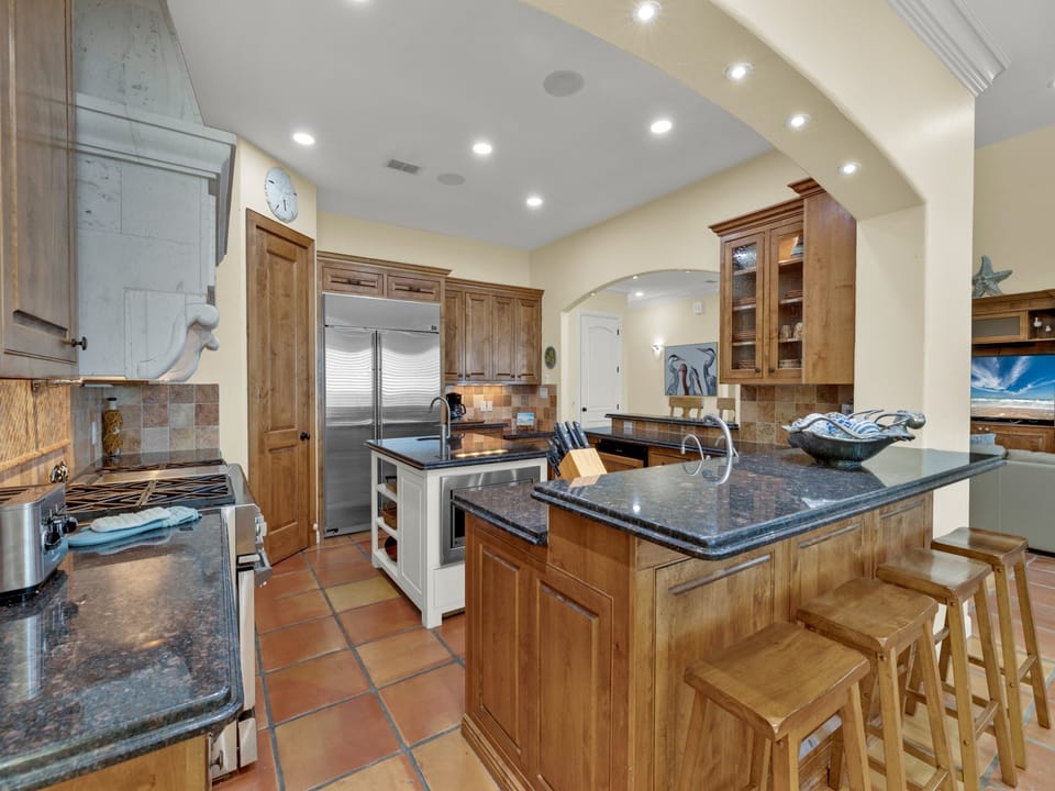 Modern kitchen with stainless steel appliances and fully stocked with kitchen wares.