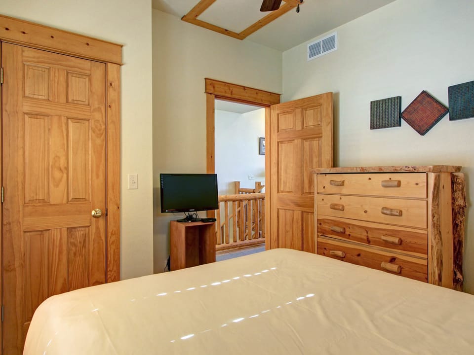 Mount Enentah 37 - Main level bedroom with queen size bed, located near the entry and the stairwell down to lower level.