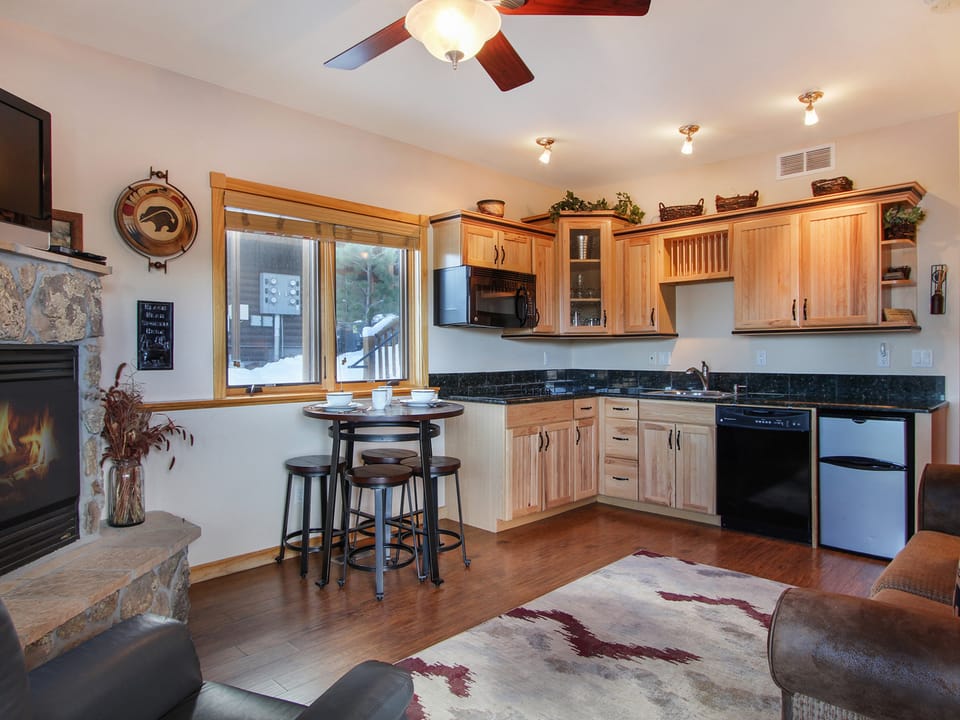 Lookout Mountain 27B - Living/dining area opens up to efficiency kitchen. Stone gas fireplace, bar table with seating for four.