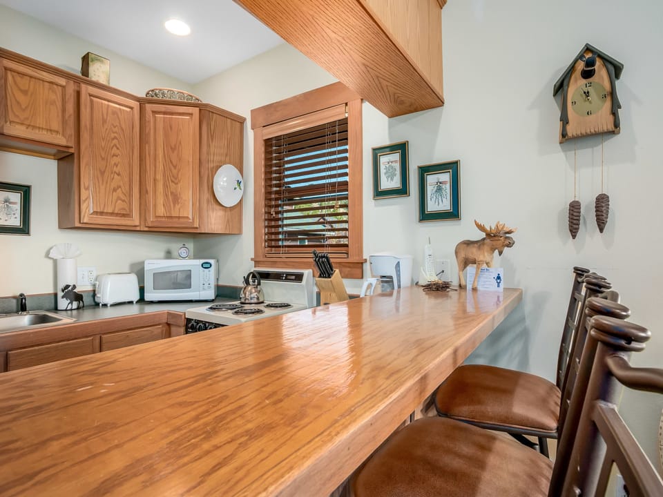 Powell Peak 104 - Bar-height counter-top seating for three guests in the kitchen area.