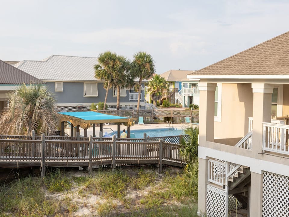 Sit on the porch and watch the swimmers enjoy a refreshing dip in the pool.