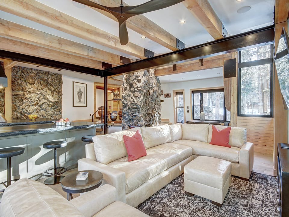 Relax on the living room sectional sofa to take in the wooded view or a watch a movie on the flat screen TV - Arrow Darrow Breckenridge Vacation Rental