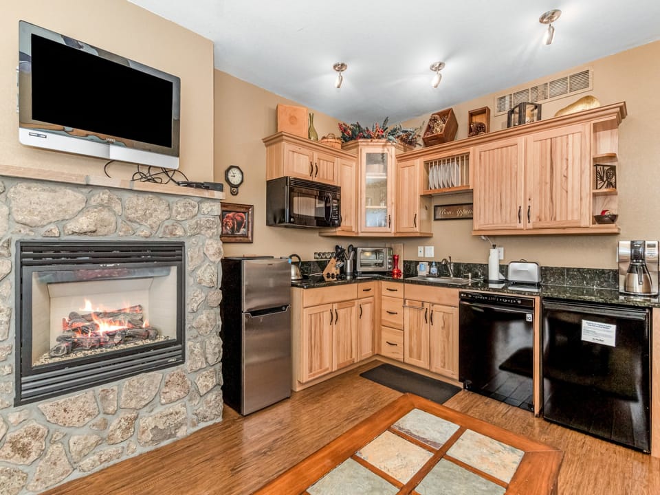 Deer Mountain 28B - Beautiful stone gas fireplace adjacent to the efficiency kitchen.