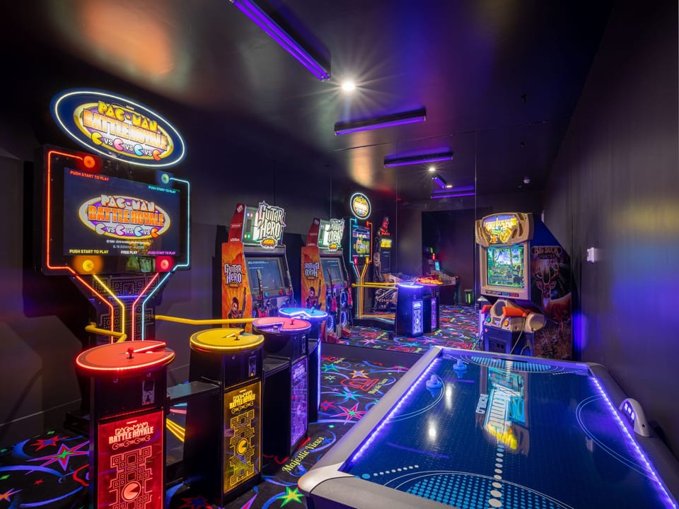 Fun for Kids and Adults this arcade room with black light lighting is the perfect addition for your guests.