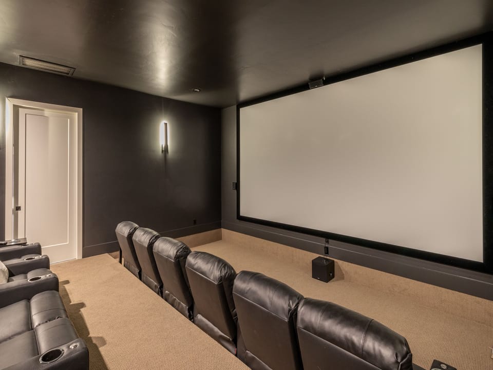 With a 200 inch screen and plenty of comfortable seating this is sure to be a fun room for everyone.