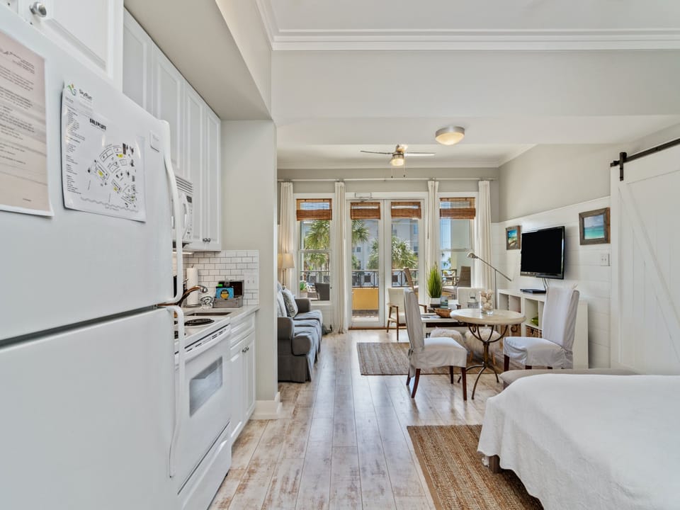 Bright 30A studio with a full kitchen, queen bed, sleeper sofa, and sunny balcony access. Steps from the beach, it’s the perfect blend of comfort and coastal style.