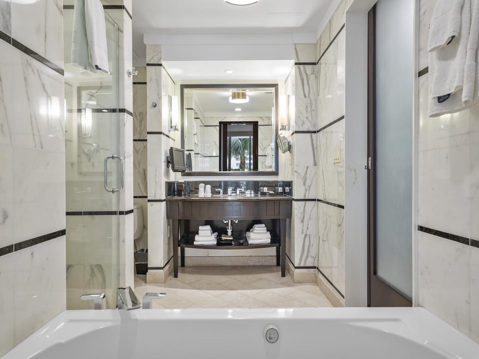 A marble-lined bathroom with a jetted spa tub