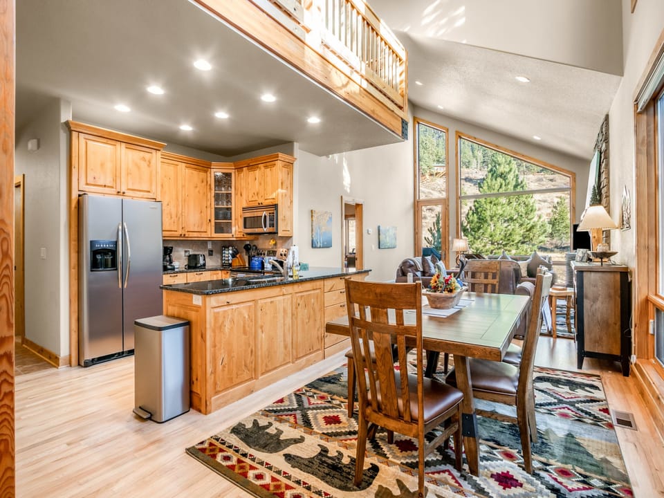 River Rock Retreat - Front door opens to a large dining table area for meals or games, the open kitchen and into the living room.