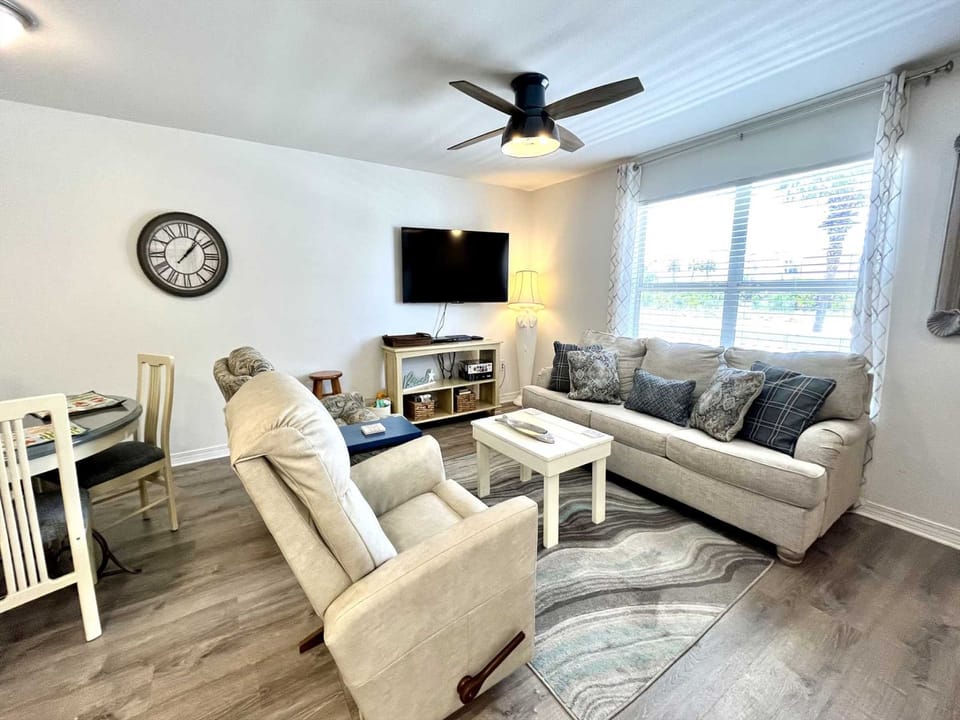 The open living room with a flat-screen, cable TV.