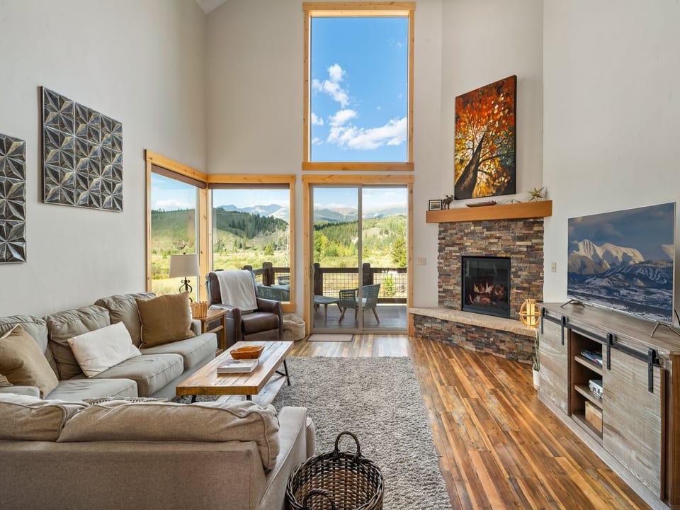 Relax by the fireplace with open living room and Mountain Views