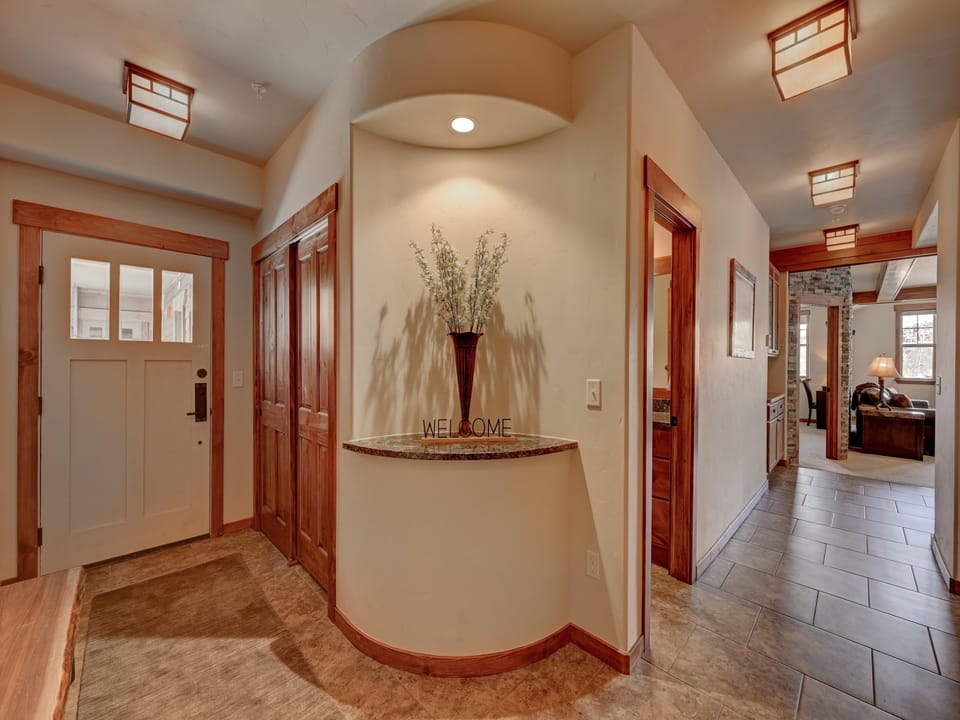 A hallway entrance with beautifully tiled floors and modern decor welcomes you