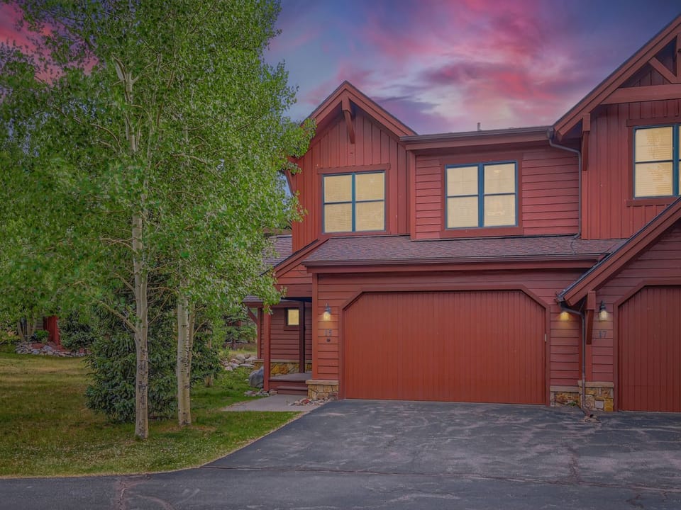 Welcome to your mountain retreat! This charming red cedar home glows warmly against the stunning sunset sky, while mature aspens provide natural privacy for your peaceful getaway.
