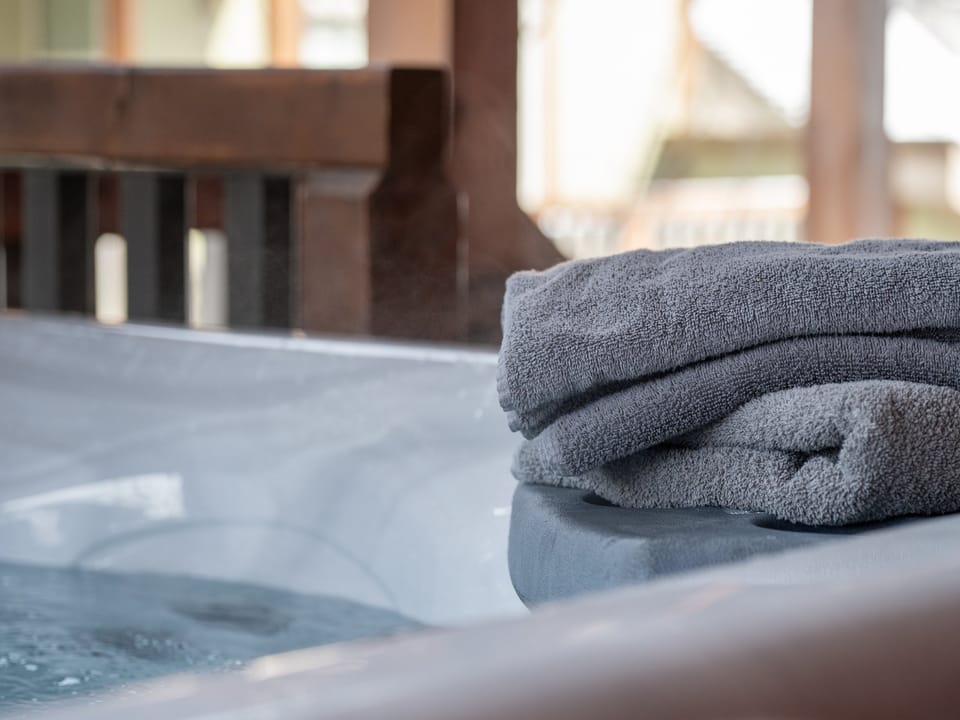 Relax in the hot tub and enjoy the mountain views