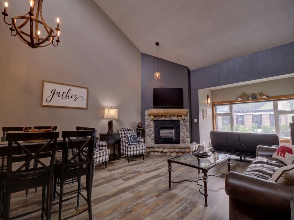 Large living room with tall ceilings and windows allowing ample natural light to come in.