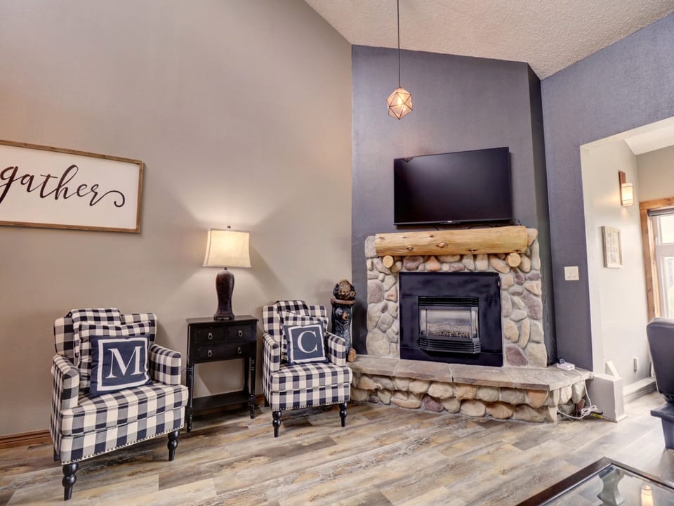 The living room features a cozy fireplace and TV.