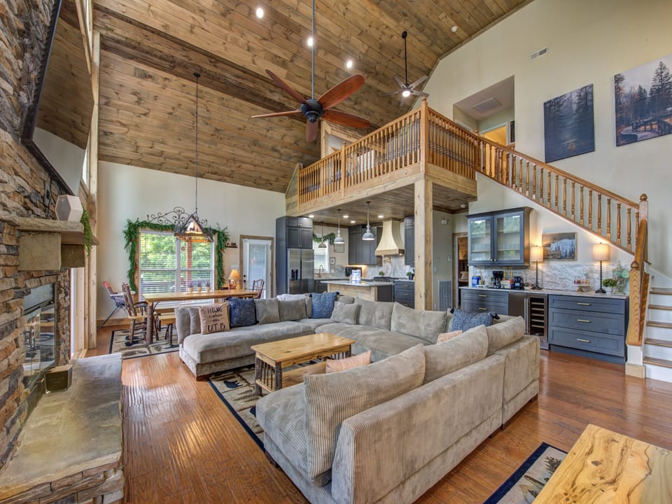 Open concept main level with soring ceiling.
