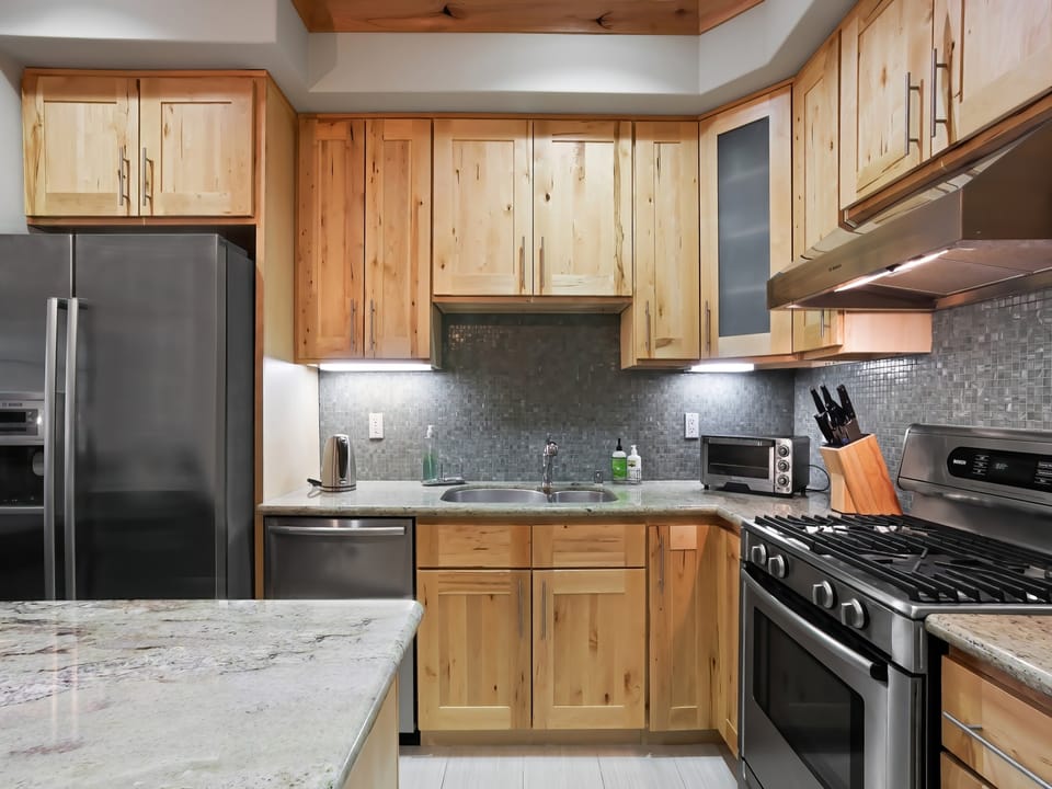 Modern, elegant kitchen complete with stainless steel appliances and well crafted pine cupboards.