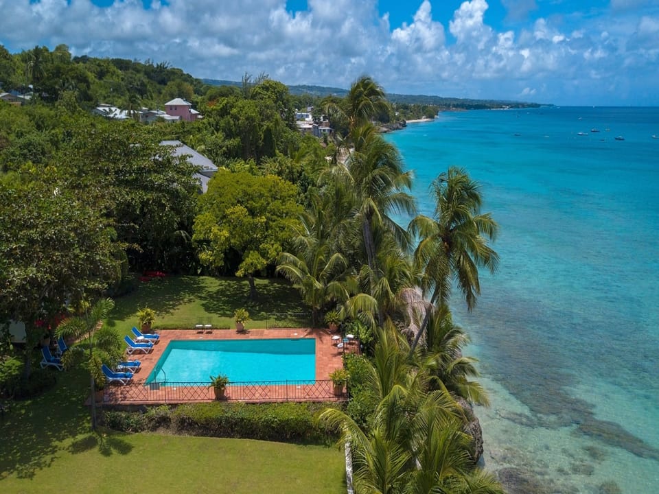 Birds eye view of the villa's pool and front garden - the beach is a minute stroll from the villa