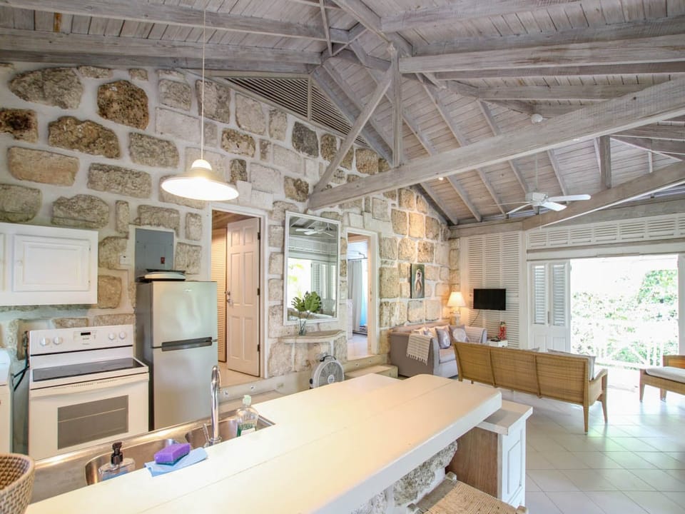The open plan living area and kitchen open up to a wrap around patio