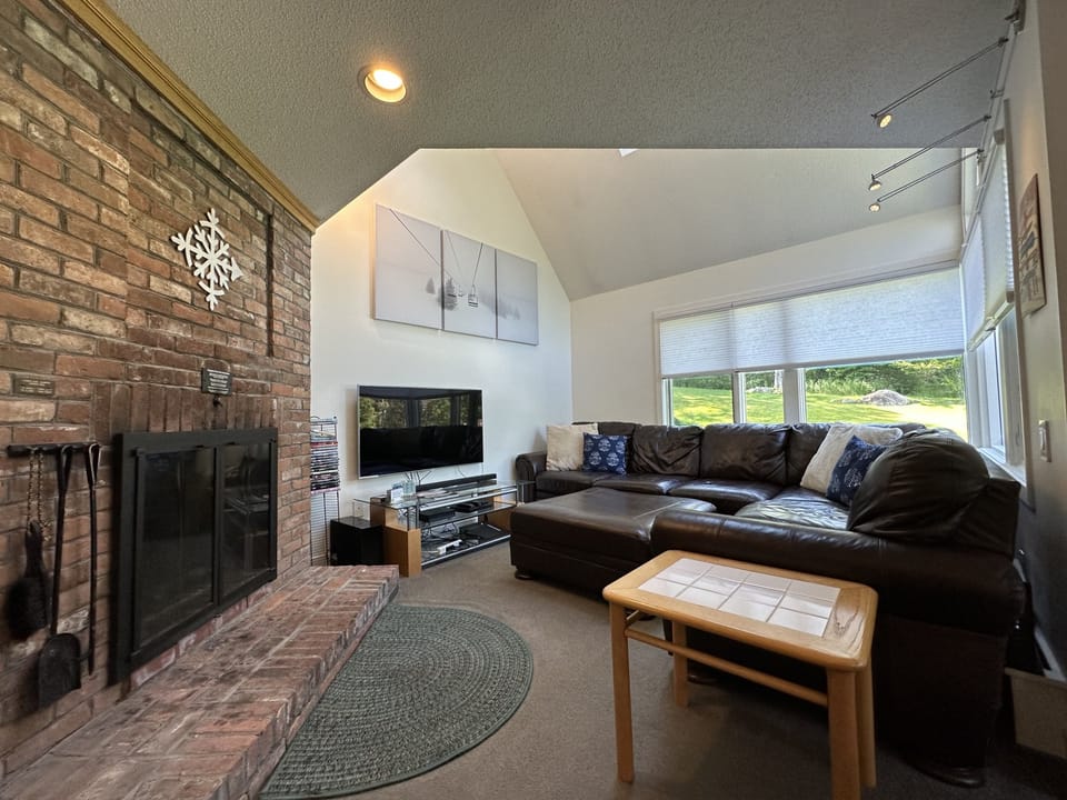 Cozy living room area and wood burning fireplace.