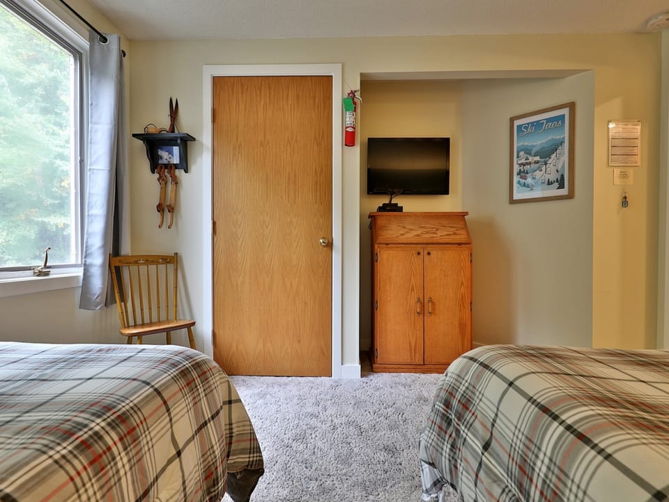 Room equipped with two twin beds TV and bathroom