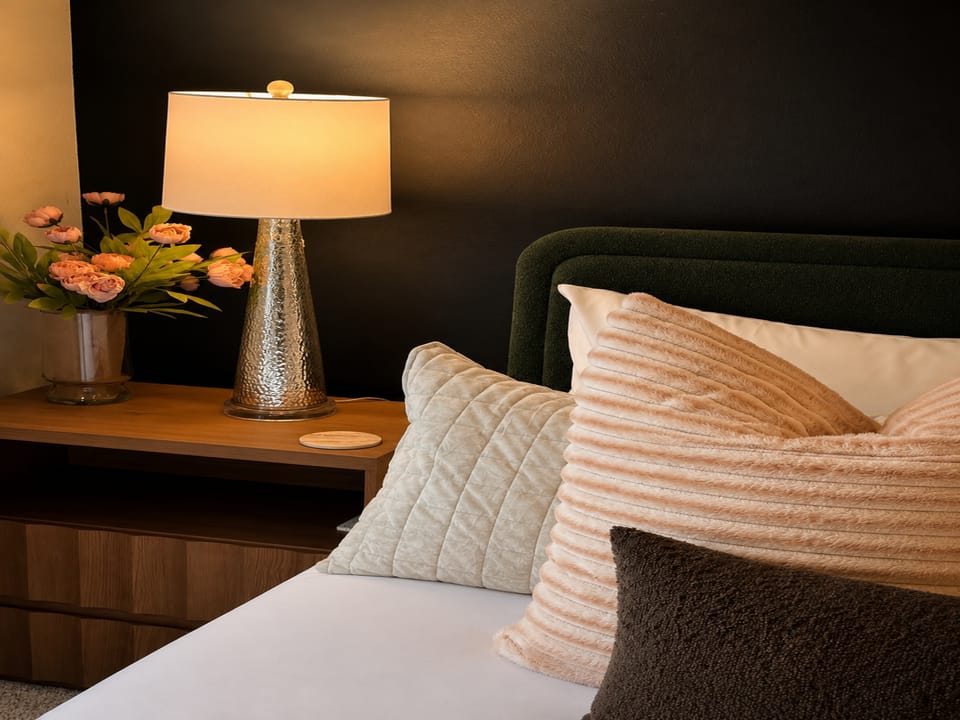 Sink into plush pillows and unwind in your serene bedroom retreat, where soft lighting and elegant touches create the perfect ambiance for rest.
