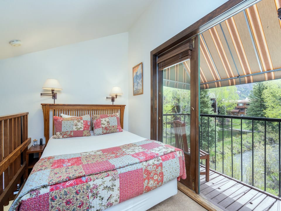 Wake up to fresh mountain air and green views just beyond your private balcony. Cozy linens and warm wood accents make this your perfect retreat after a day of adventure.