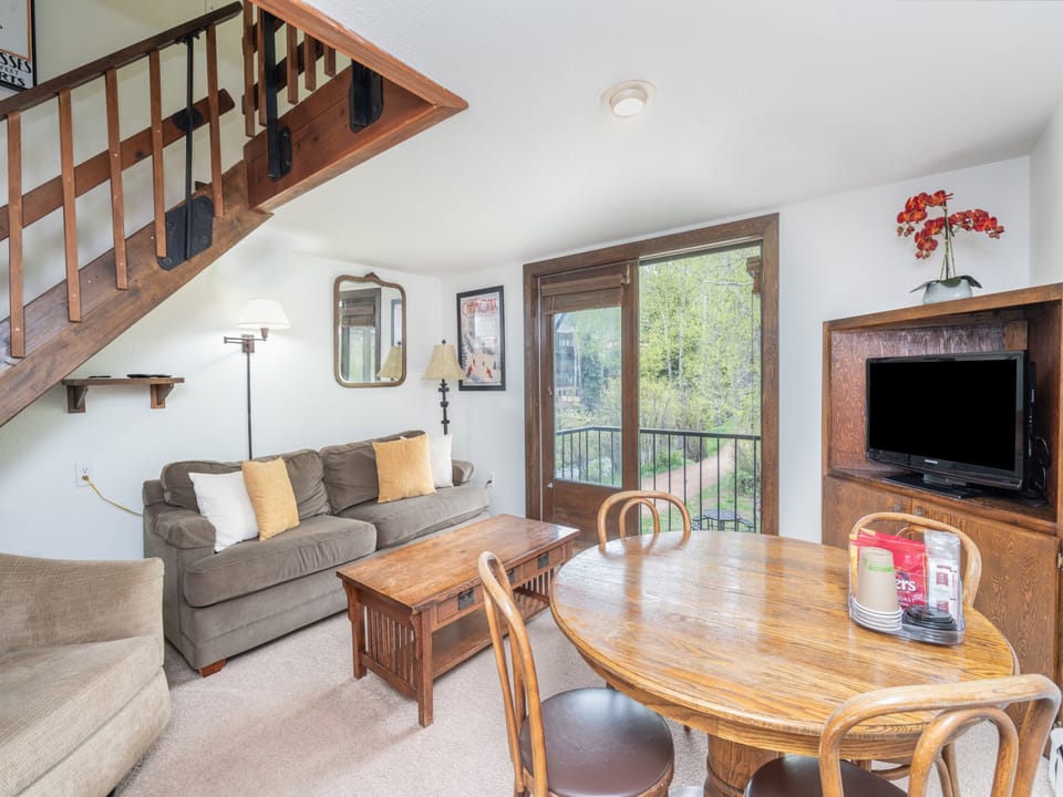 Relax in your inviting living space with cozy seating, natural light, and easy access to your private balcony overlooking peaceful greenery.