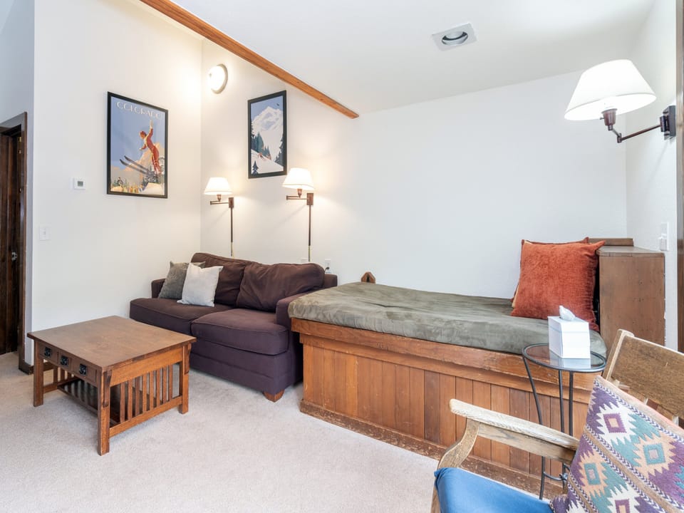 Settle into this cozy living space with a plush sofa, warm wood accents, and charming ski-themed artwork that captures the alpine spirit. Your perfect retreat after a day exploring the mountains.