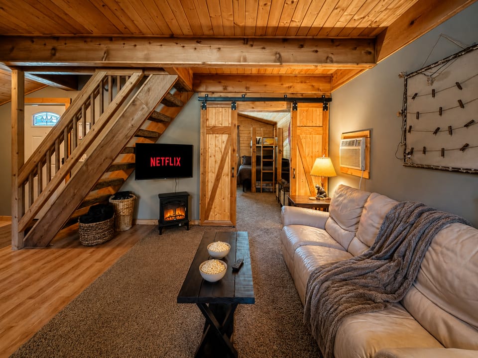 Cozy living area space offers streaming TV, electric fireplace, comfy furniture and a simple place to relax.