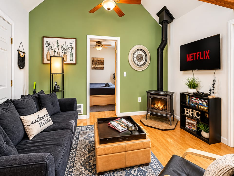 Sink into plush seating by the glowing fireplace, enjoy your favorite shows, and unwind in this inviting space designed for your ultimate relaxation.