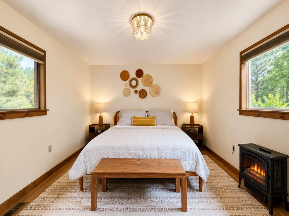Main Floor Bedroom with King Bed and Electric Fireplace
