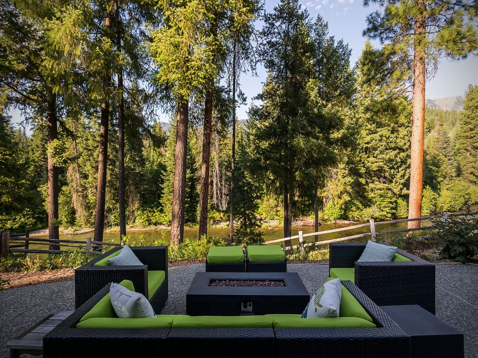 Patio propane fire pit seating with a view of the Chiwawa River