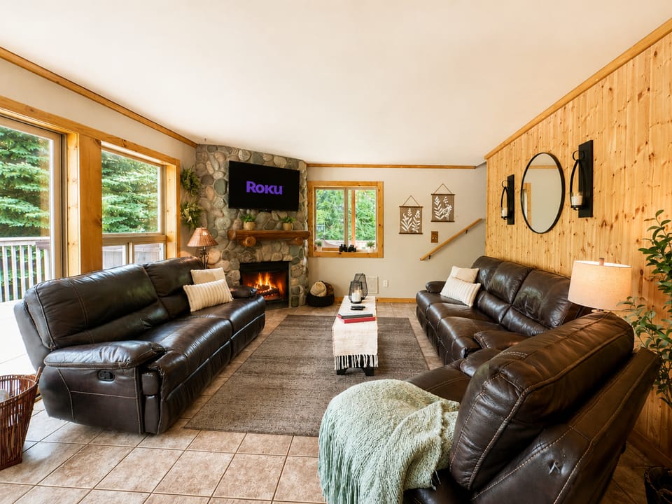 Cozy main floor living area with gas fireplace, views from the windows and ROKU TV for streaming.