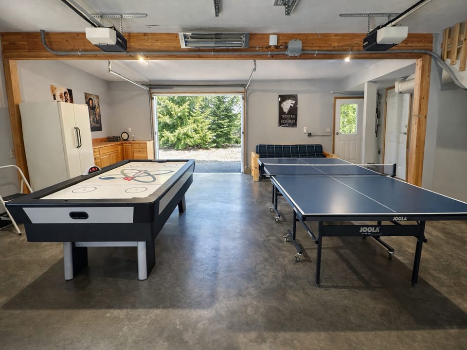 The garage space serves as a game room with ping pong and air hockey.