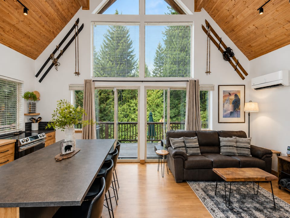 Open Concept Living Space with electric fireplace, picture windows and a cozy vibe.