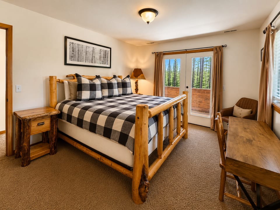 Primary Bedroom with King Bed and work station, en suite with shower and private balcony.