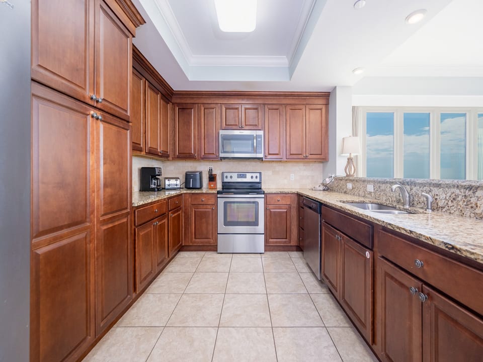 Sunlight reflects off granite counters as you prepare fresh meals in the bright kitchen space