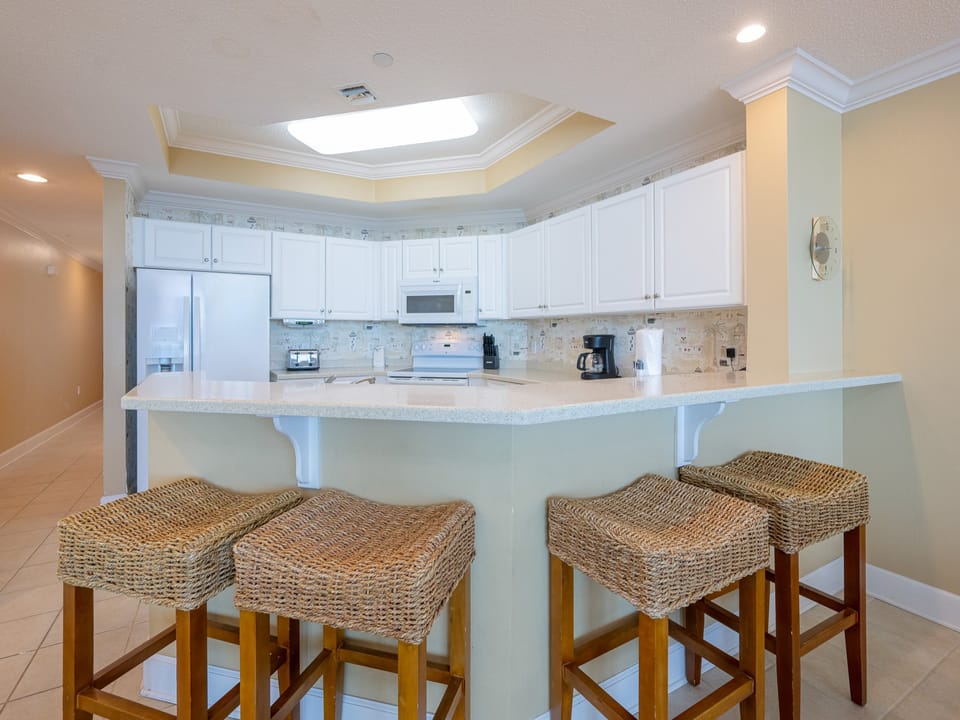 Enjoy casual conversations around the textured bar stools, creating lasting memories in the heart of this inviting kitchen