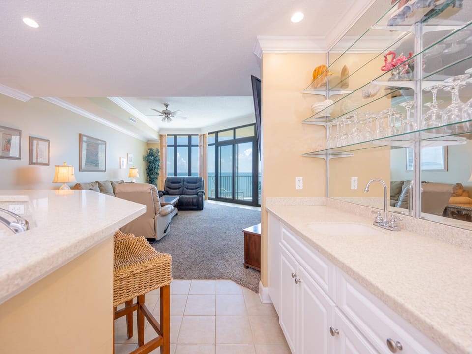 Wake up with morning coffee at the breakfast bar and get ready for a beach day in this stylish space