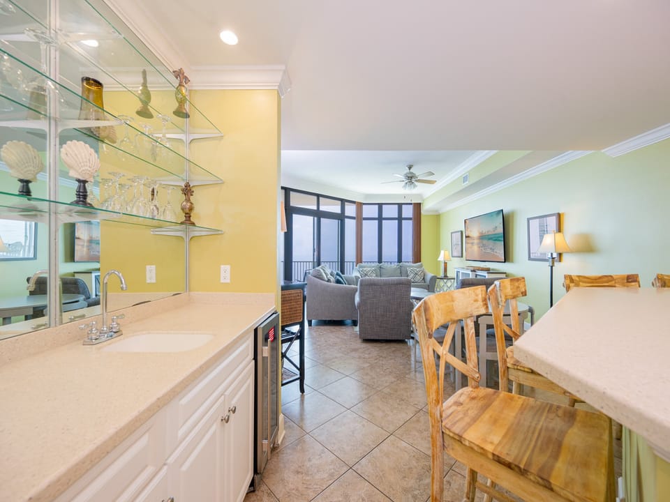 Rustic wooden stools line the bar where you pour cool drinks while sharing stories in your vacation rental