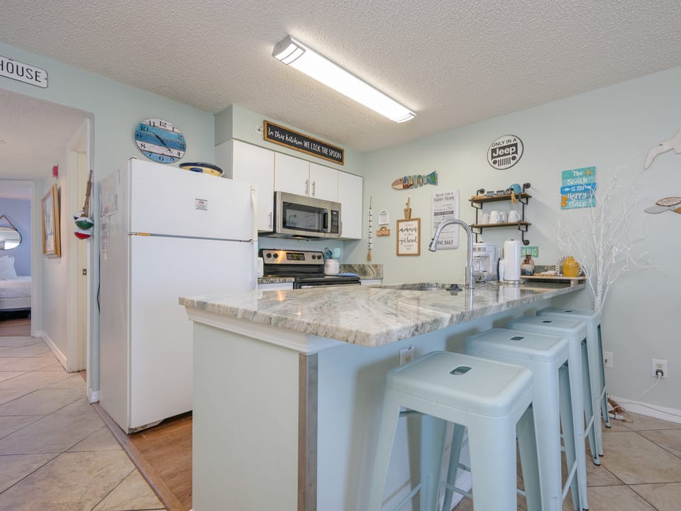 The kitchen features granite countertops, stainless appliances, and a cozy dining area, perfect for enjoying meals together