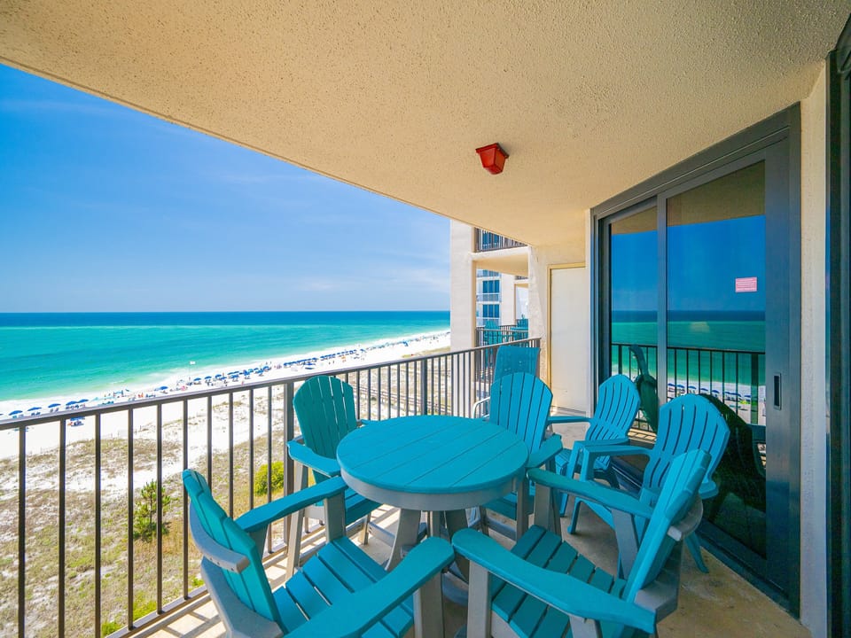 Enjoy the fresh gulf air on the balcony with views of the beach and inviting lounge chairs for relaxation