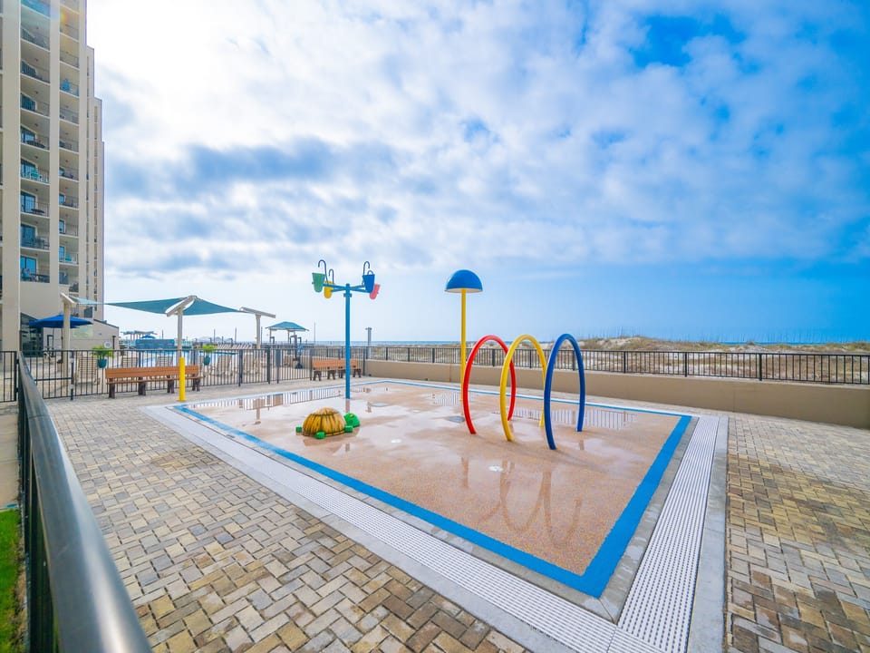 Enjoy the vibrant splash park area, perfect for family fun, with colorful play equipment and beach nearby