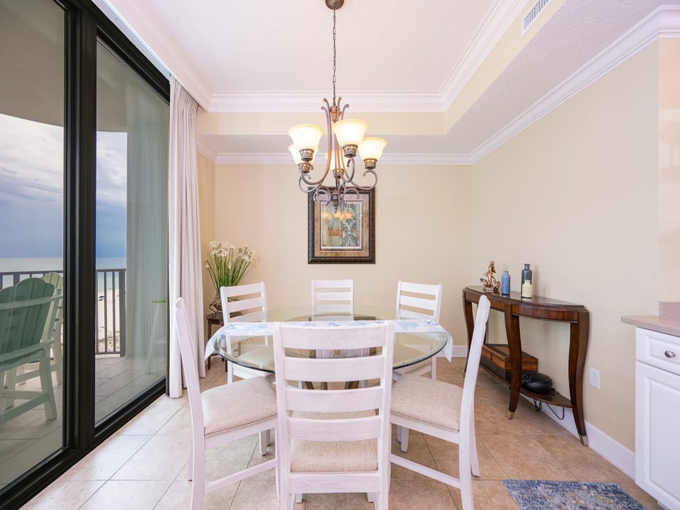Dine in this elegant space with a glass table, plush seating, and views that invite relaxation and conversation