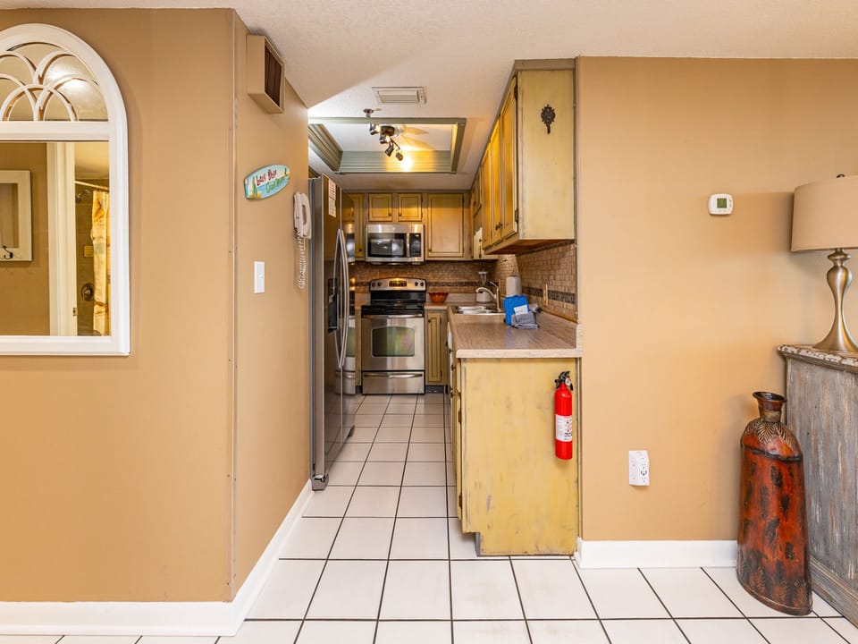Whip up family-favorite meals in this cozy kitchen, complete with white appliances and stylish countertops