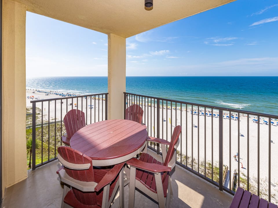 Relax on the balcony with a round table and Adirondack chairs, overlooking the beach and tranquil turquoise waters
