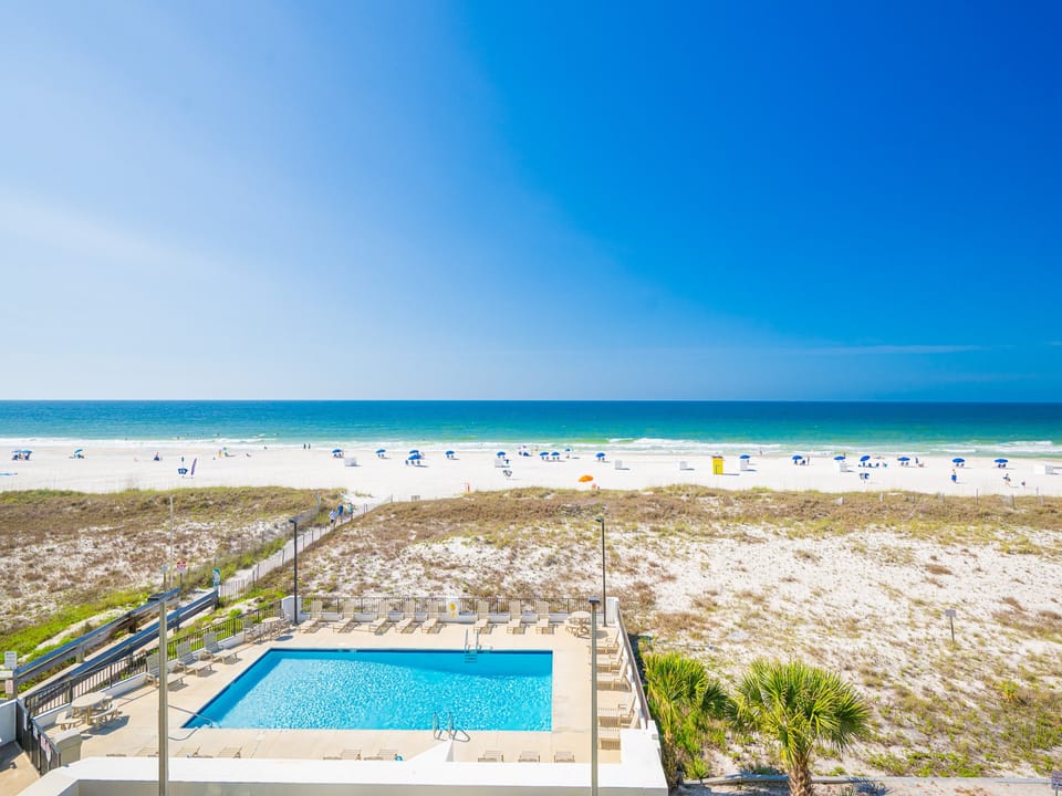 Enjoy a breathtaking view from this inviting poolside area, perfect for relaxation and sunbathing