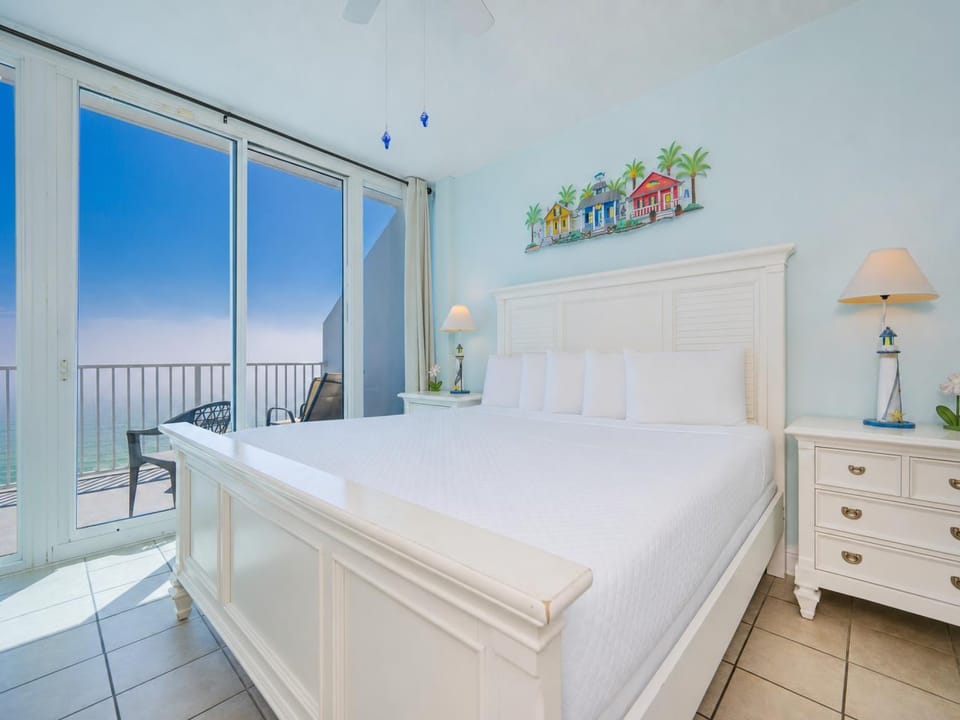 Soft daylight fills the suite as you relax on the king bed and gaze out toward the shimmering shore beyond your balcony